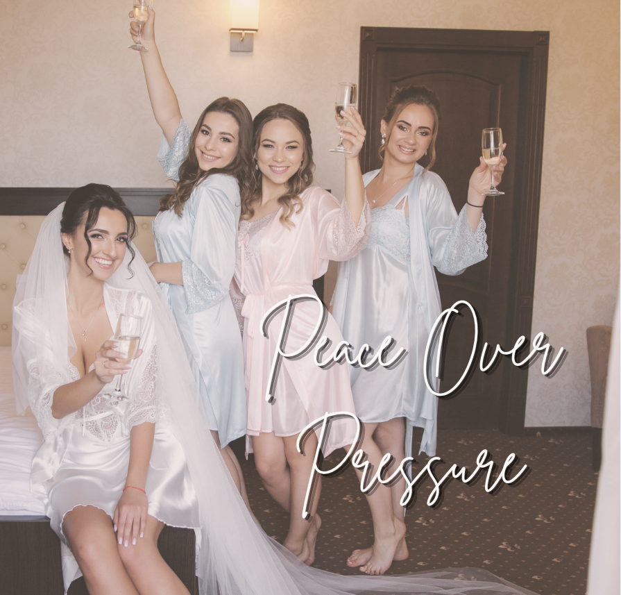 Happy bride and bridesmaids in pjs with champagne at hotel room